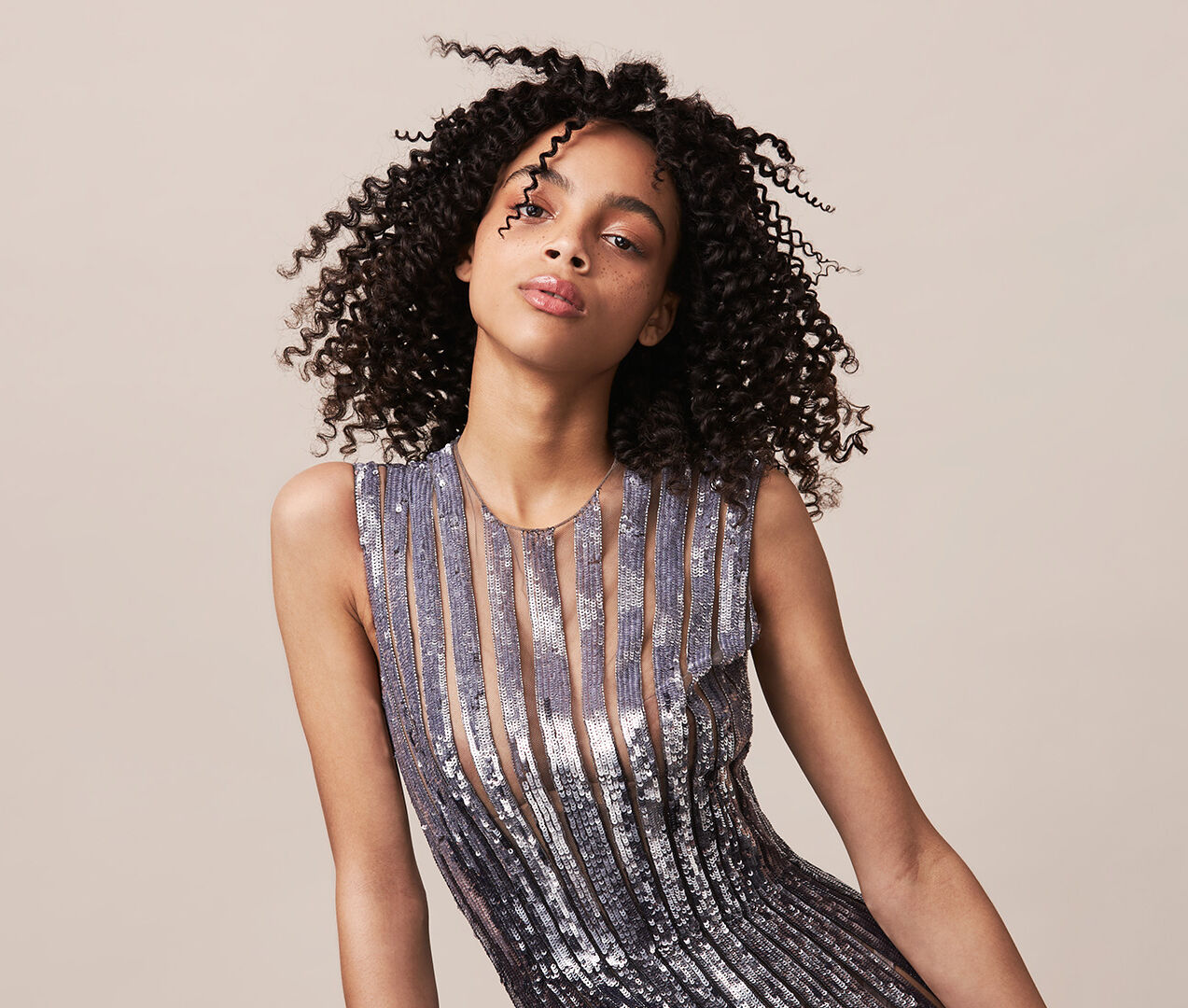 Glamorous look featuring curly hair and metallic dress